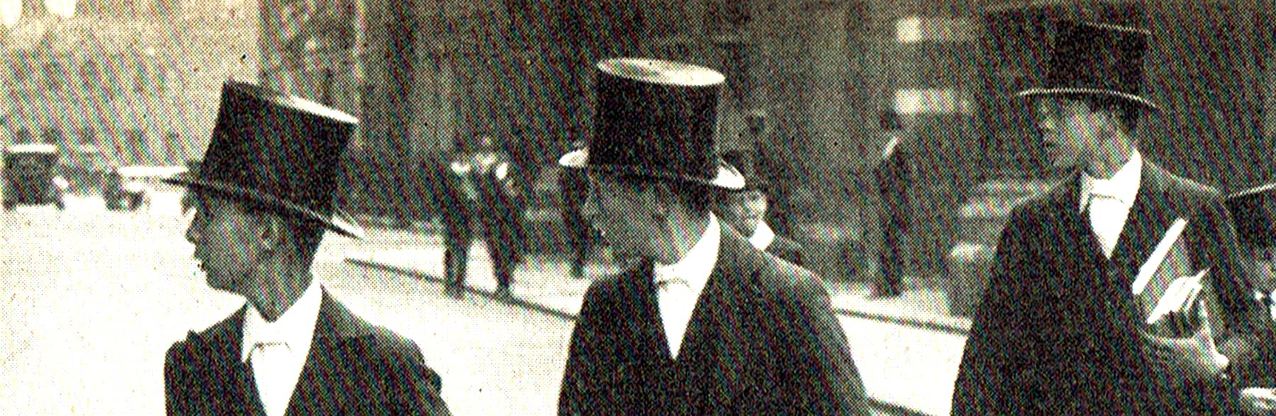 Detail from an old photo: Etonians crossing a street and looking all in one direction.